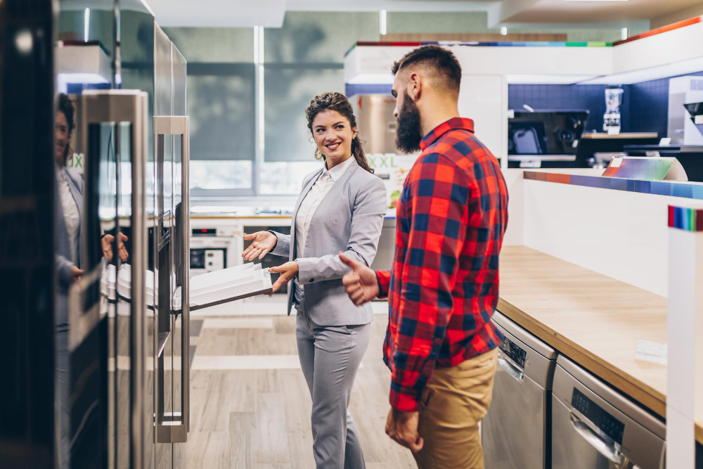 Sales lady talking to a guy buying a fridge